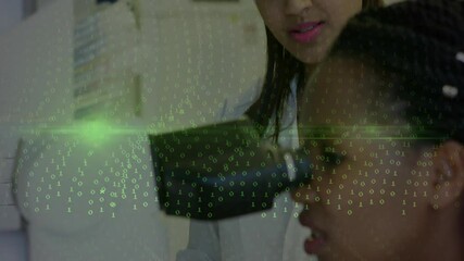 Lab instructor reviewing tablet data and guiding trainee to microscope focus showing binary overlay - Powered by Adobe