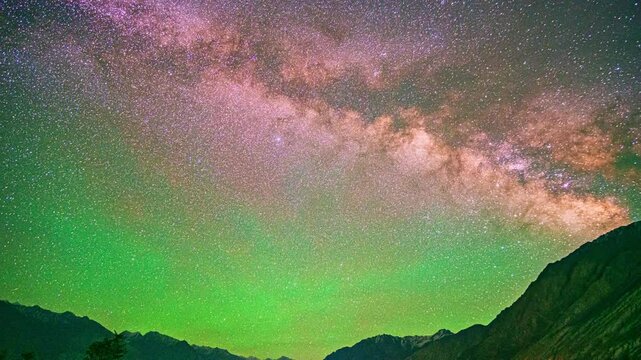 Time lapse The Milky Way stands perpendicular to the summit of Himalayan. Clouds followed by, obscuring the sky and stars. The night sky sparkles with stars. wonderful and mesmerizing picture.
