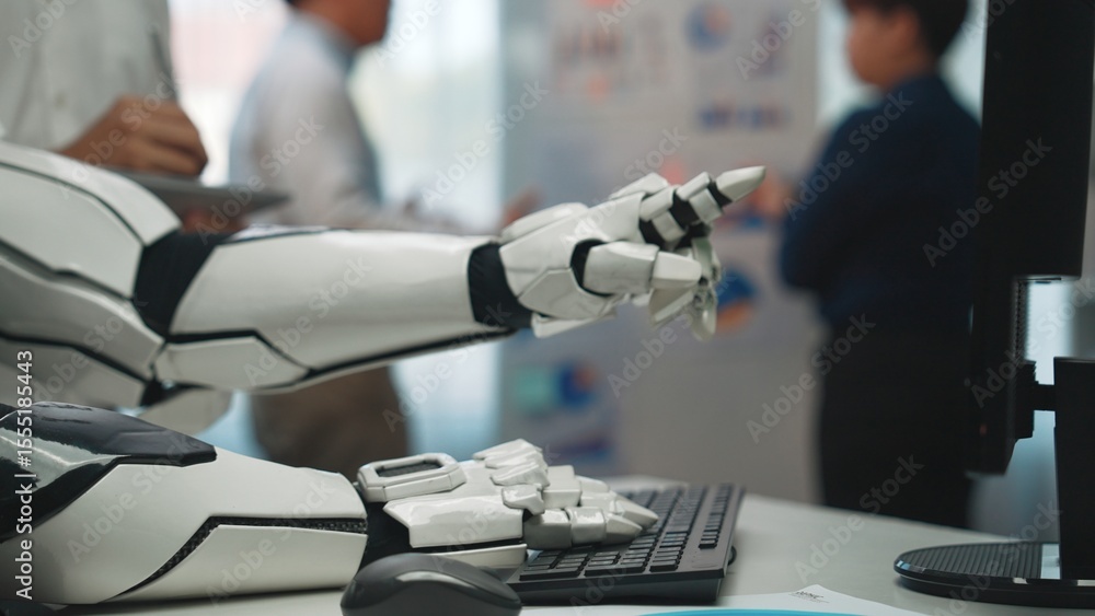 Poster a robotic hand extends towards a keyboard in a modern office. professionals engage in discussions, h