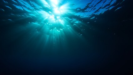 Obraz premium Underwater scene depicting sunbeams piercing through the ocean's surface creating depth