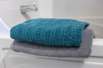 A neatly folded towel placed in a bathroom, ready for use and evoking cleanliness and comfort