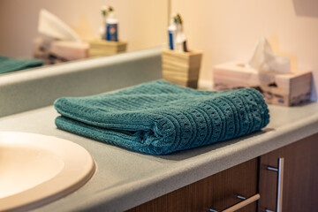 A neatly folded towel placed in a bathroom, ready for use and evoking cleanliness and comfort