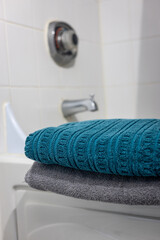 A neatly folded towel placed in a bathroom, ready for use and evoking cleanliness and comfort