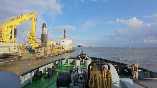 VSP tugboat at a work site next to the pontoon with an excavator.
Cuxhaven, Lower Saxony, Germany
4K 60fps
