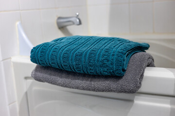 A neatly folded towel placed in a bathroom, ready for use and evoking cleanliness and comfort