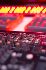 Close-Up of Professional Audio Mixer Console with Colorful Knobs