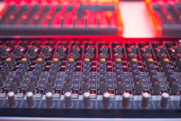 Close-Up of Professional Audio Mixer Console with Colorful Knobs