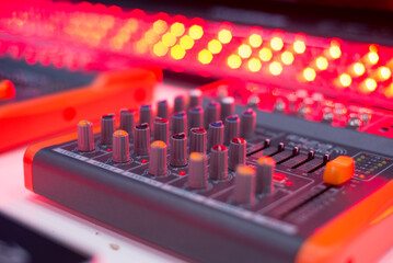 Close-Up of Professional Audio Mixer Console with Colorful Knobs