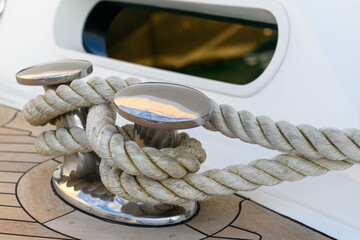 Bollard (cleat) with mooring line on superyacht. Mooring gear on yacht. Superyacht equipment.