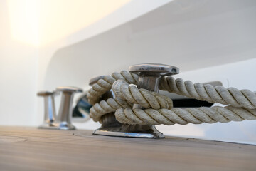 Bollard (cleat) with mooring line on superyacht. Mooring gear on yacht. Superyacht equipment. Side...