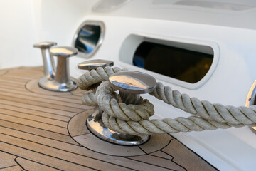 Bollard (cleat) with mooring line on superyacht. Mooring gear on yacht. Superyacht equipment. Side...