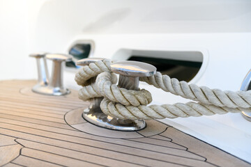 Bollard (cleat) with mooring line on superyacht. Mooring gear on yacht. Superyacht equipment. Side...