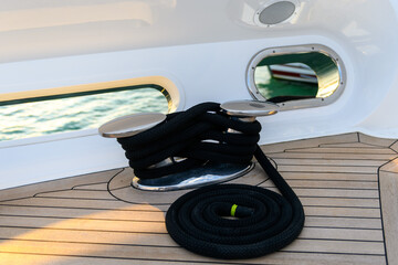 Mooring line coiled on deck on superyacht. Mooring gear on yacht. Superyacht equipment. 