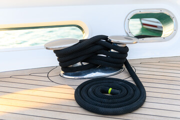 Mooring line coiled on deck on superyacht. Mooring gear on yacht. Superyacht equipment. 