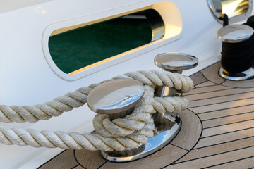 Bollard (cleat) with mooring line on superyacht. Mooring gear on yacht. Superyacht equipment. Side...