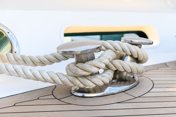 Bollard (cleat) with mooring line on superyacht. Mooring gear on yacht. Superyacht equipment. Side...