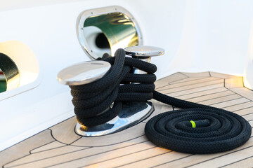 Mooring line coiled on deck on superyacht. Mooring gear on yacht. Superyacht equipment. 