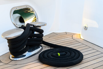 Mooring line coiled on deck on superyacht. Mooring gear on yacht. Superyacht equipment. 