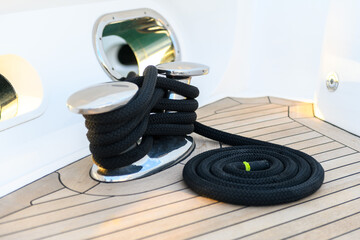 Mooring line coiled on deck on superyacht. Mooring gear on yacht. Superyacht equipment. 