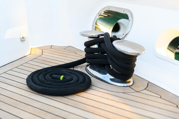 Mooring line coiled on deck on superyacht. Mooring gear on yacht. Superyacht equipment. 