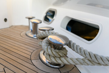 Bollard (cleat) with mooring line on superyacht. Mooring gear on yacht. Superyacht equipment. Side view.
