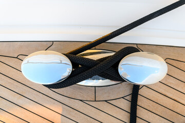 Bollard (cleat) with mooring line on superyacht. Mooring gear on yacht. Superyacht equipment. Top view.