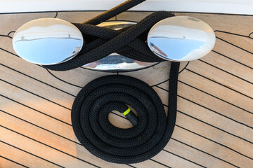 Mooring line coiled on deck on superyacht. Mooring gear on yacht. Superyacht equipment. 