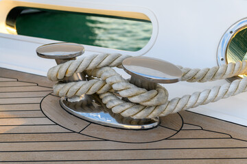Bollard (cleat) with mooring line on superyacht. Mooring gear on yacht. Superyacht equipment. Side view.