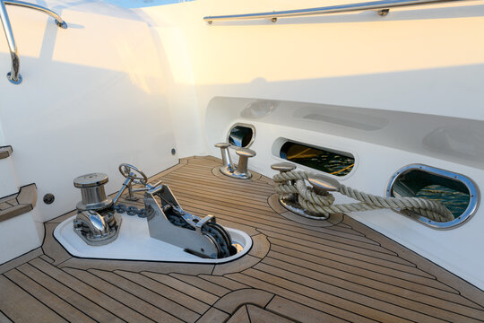 Anchor winch and cleat on superyacht. Anchoring and mooring gear on the bow of yacht. Superyacht equipment. 
