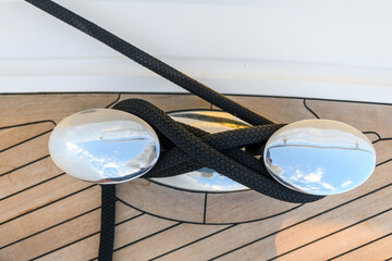 Bollard (cleat) with mooring line on superyacht. Mooring gear on yacht. Superyacht equipment. Top view.