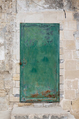 Old rusty metal gate, painted green. Metal structure.