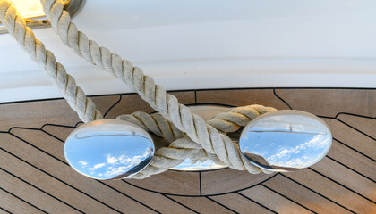 Bollard (cleat) with mooring line on superyacht. Mooring gear on yacht. Superyacht equipment. 