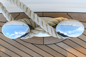 Bollard (cleat) with mooring line on superyacht. Mooring gear on yacht. Superyacht equipment. 