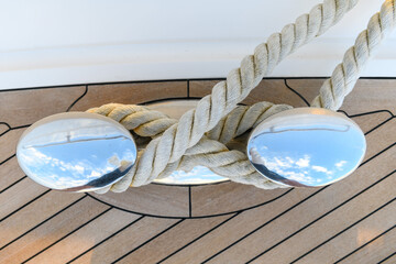 Bollard (cleat) with mooring line on superyacht. Mooring gear on yacht. Superyacht equipment. Top view.