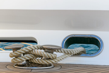 Bollard (cleat) with mooring line on superyacht. Mooring gear on yacht. Superyacht equipment. Side view.