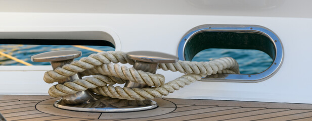 Bollard (cleat) with mooring line on superyacht. Mooring gear on yacht. Superyacht equipment. Side view.