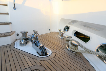 Anchor winch and cleat on superyacht. Anchoring and mooring gear on the bow of yacht. Superyacht equipment. 