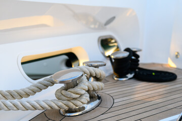 Bollard (cleat) with mooring line on superyacht. Mooring gear on yacht. Superyacht equipment. 