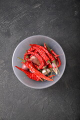 Dry dried red chili pepper in plastic circle container