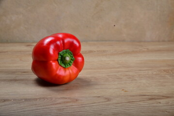 Sweet Bulgarian fresh bright pepper on light wood background
