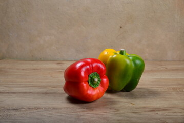Sweet Bulgarian fresh bright pepper on light wood background