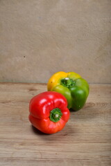 Sweet Bulgarian fresh bright pepper on light wood background