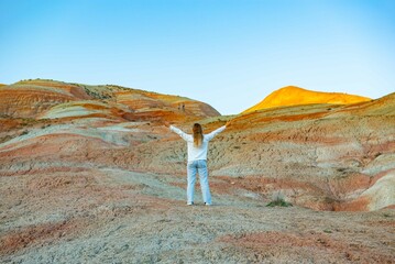 Girl walking in the mountains of Khizi at sunset