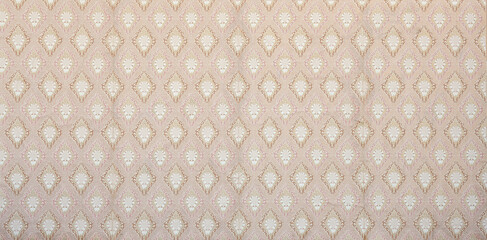 Old wallpaper on the wall. Old wallpaper for texture or background.