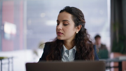 Businesswoman winner reading smartphone message in panoramic office closeup