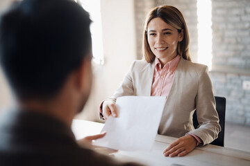 Female banker with client in office