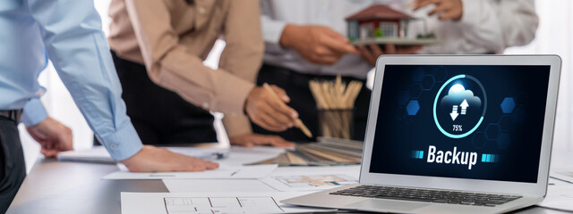 Group of interior architect designer discussing together on blueprint and laptop screen display...