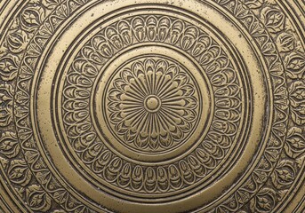 Obraz premium Ornate Brass Metal Pattern. Detail of an antique brass surface with rich, elaborate engravings. Its circular patterns convey harmony and tradition, highlighting meticulous artisan work.
