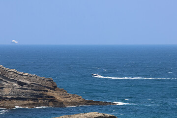 Seascape. Boats. Cape on the coast. Rock formation.