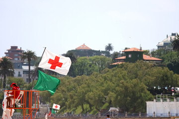 Santander, Cantabria, Spain; 06, 09, 2025: Green flag and lifeguard flag on a beach.